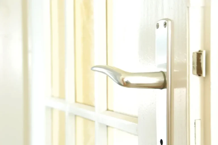 How to change a uPVC door lock in Runcorn – white door with a lever handle on a long backplate, Locksmith Runcorn guide to barrel, handle and multipoint replacement