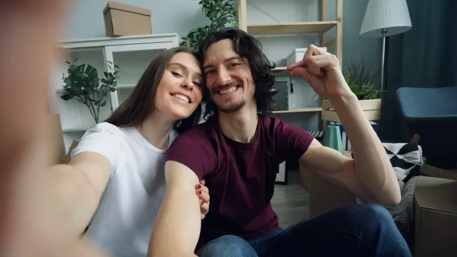 Couple holding up keys in their new home – residential locksmith Runcorn help for homeowners from Locksmith Runcorn